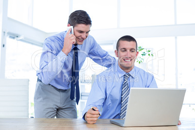 Businessmen using laptop