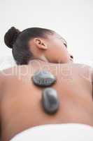 Peaceful pretty woman enjoying a hot stone massage