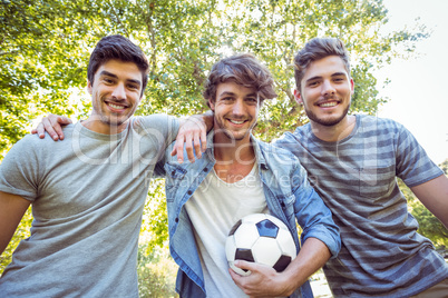 Happy friends in the park with football