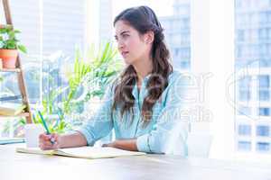 Woman taking notes during a meeting