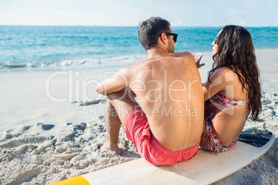 happy couple with surfboard on a sunny day happy couple with surfboard on a sunny day