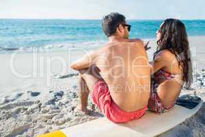 happy couple with surfboard on a sunny day