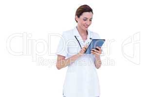 Smiling doctor using tablet