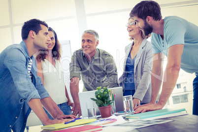 Five casual colleagues using laptop