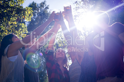 Happy friends in the park having beers