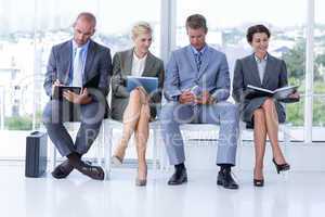 Business people waiting to be called into interview