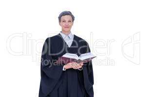 Lawyer looking at camera and holding law code