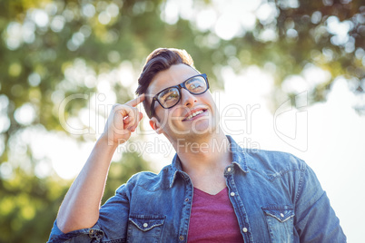 Handsome thinking hipster in the park