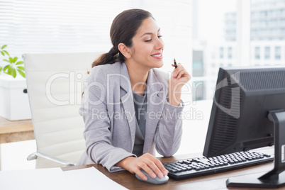 Smiling businesswoman using her computer