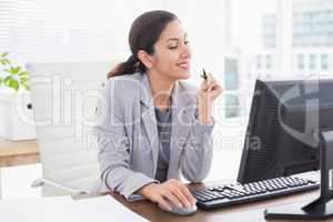 Smiling businesswoman using her computer