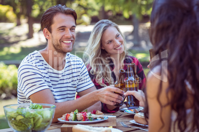 Happy friends in the park having lunch