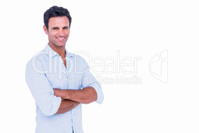 Happy handsome man looking at camera with arms crossed Happy handsome man looking at camera with arms crossed