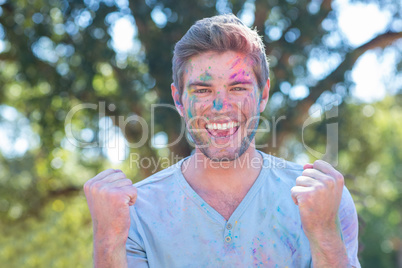 Happy man covered in powder paint