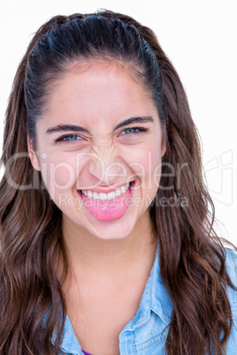 Happy brunette grimacing at camera