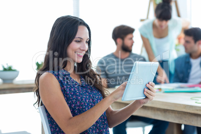 Smiling young women using digital tablet