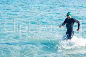 Swimmer running in the ocean