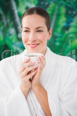 Close up portrait of a beautiful young woman drinking a coffee