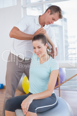 Woman stretching her arm with trainer