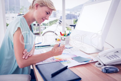 Creative businesswoman drawing plans using colour watch