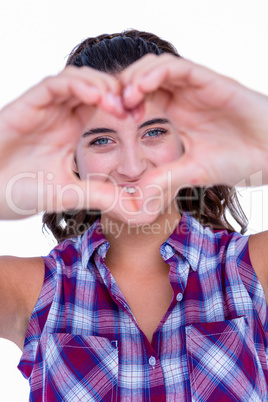 Happy pretty woman making heart shape with hands