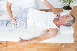 Physiotherapist doing leg massage to her patient