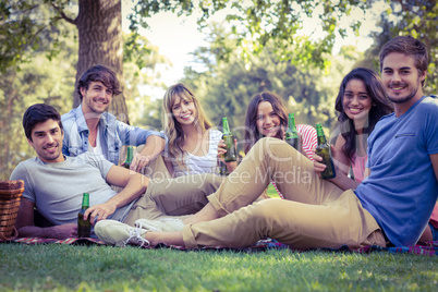 Happy friends in the park having picnic