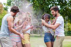 Happy friends throwing powder paint