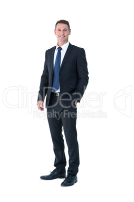 Businessman looking at camera with hand in pocket