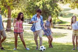 Happy friends in the park with football