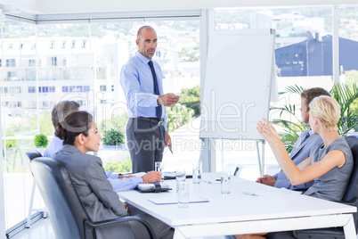 Businesswoman asking question during meeting