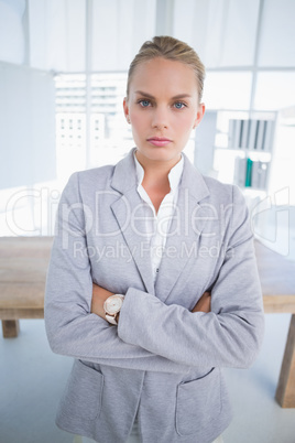Unhappy businesswoman looking at camera with arms crossed Unhappy businesswoman looking at camera with arms crossed