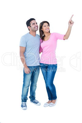 Happy couple standing together and looking away Happy couple standing together and looking away