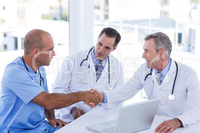 Doctors doing hands shakes