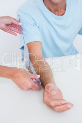 Doctor measuring arm with goniometer