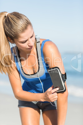 Portrait of beautiful fit woman using her phone