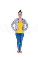 Businesswoman looking at camera with hands on hips