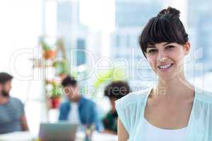 Smiling young businesswoman looking at the camera