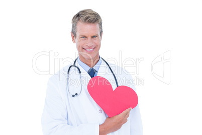 Smiling doctor holding heart card