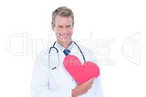 Smiling doctor holding heart card