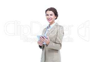 Businesswoman smiling while holding a tablet