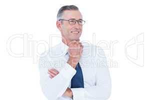 thinking businessman standing with hand on chin