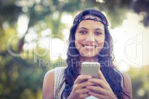 Pretty hipster using her smartphone