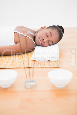 Peaceful pretty woman lying a bamboo mat