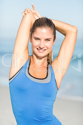 Beautiful fit woman stretching her arm