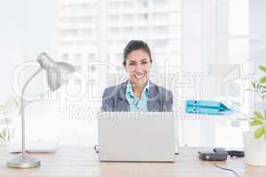 Smiling businesswoman using her computer