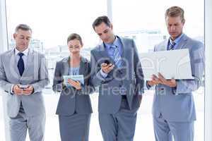 Business colleagues using their multimedia devices