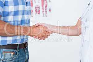 Patient shaking hands with doctor