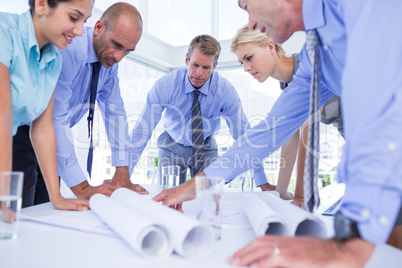 team of business people looking at construction plan