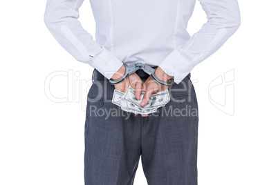 Wear view of businessman with handcuff and money in hands