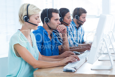 Call centre workers on their laptops